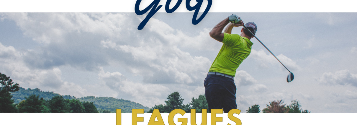 Golfer mid-swing on a sunny golf course with mountains in the background.
