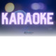 Bright neon sign glowing with the word 'KARAOKE' in purple and white.